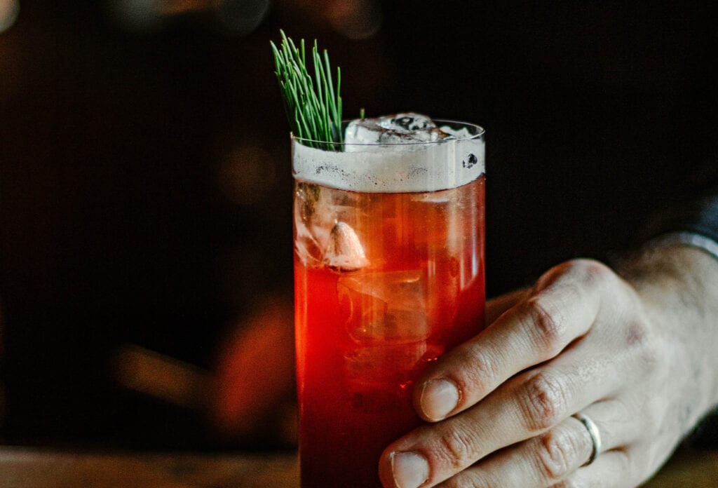 Man holding red cocktail